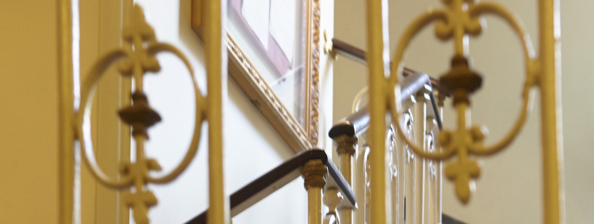 Golden stairwell in International au Lac Historic Lakeside Hotel