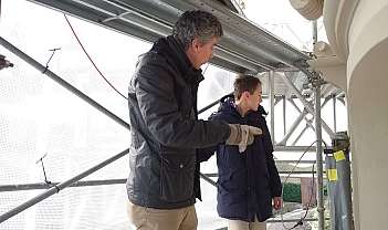 Deux hommes en vestes d'hiver sur une échafaudage métallique lors d'une inspection