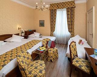 Interior of a hotel room with elegant beds and decorations.