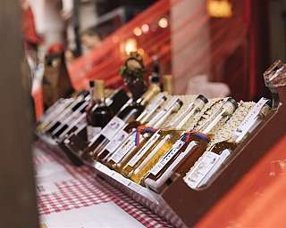 A variety of bottles of liqueurs displayed on a table.