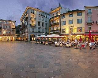 Panoramablick auf einen Platz mit Restaurants und historischen Gebäuden.