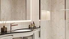 Interior of a bathroom with shower, sink and illuminated mirror.