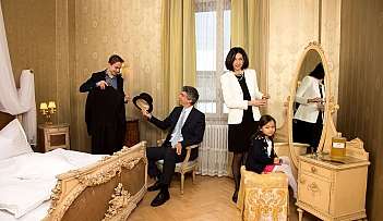 Quattro persone in una camera elegante con mobili antichi e decorazioni dorate