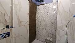 Interior of a bathroom under renovation with tiles.