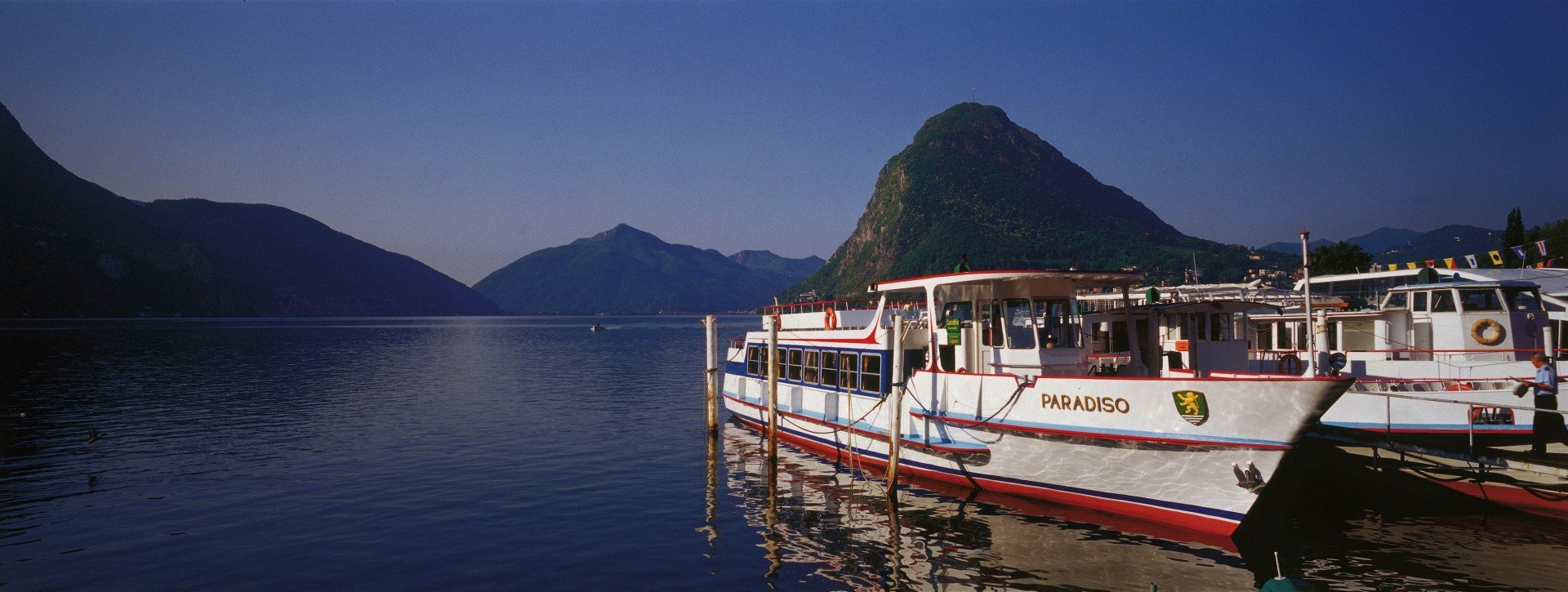 Boats on the Lugano lake in the evening