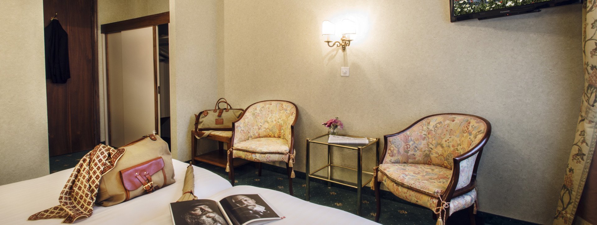 Bedroom with two chairs in floral and antic design