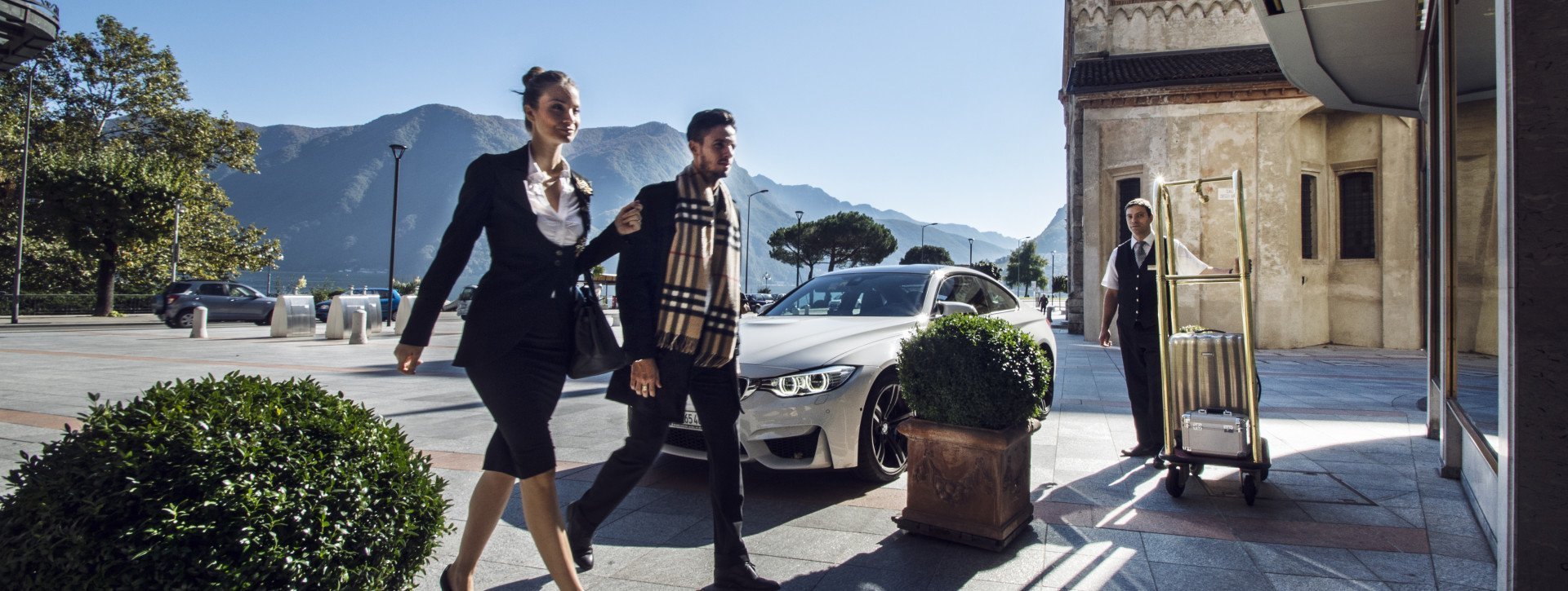 A business couple arrive at International au Lac Historic Lakeside Hotel