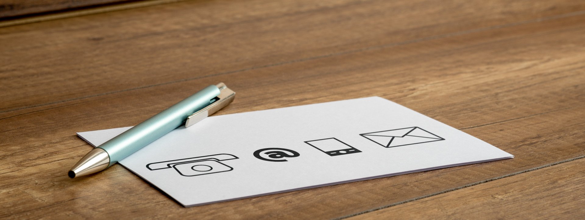 Pen and paper on a wooden table