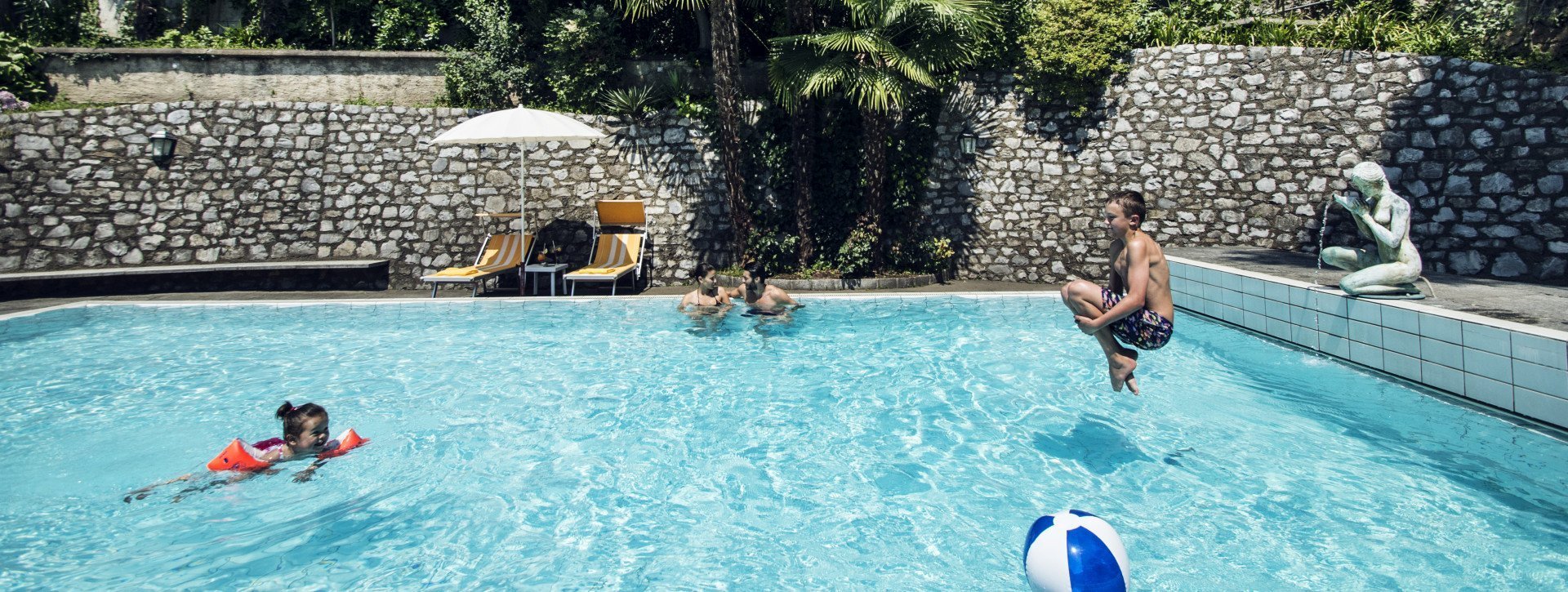 A boy jumps into the pool