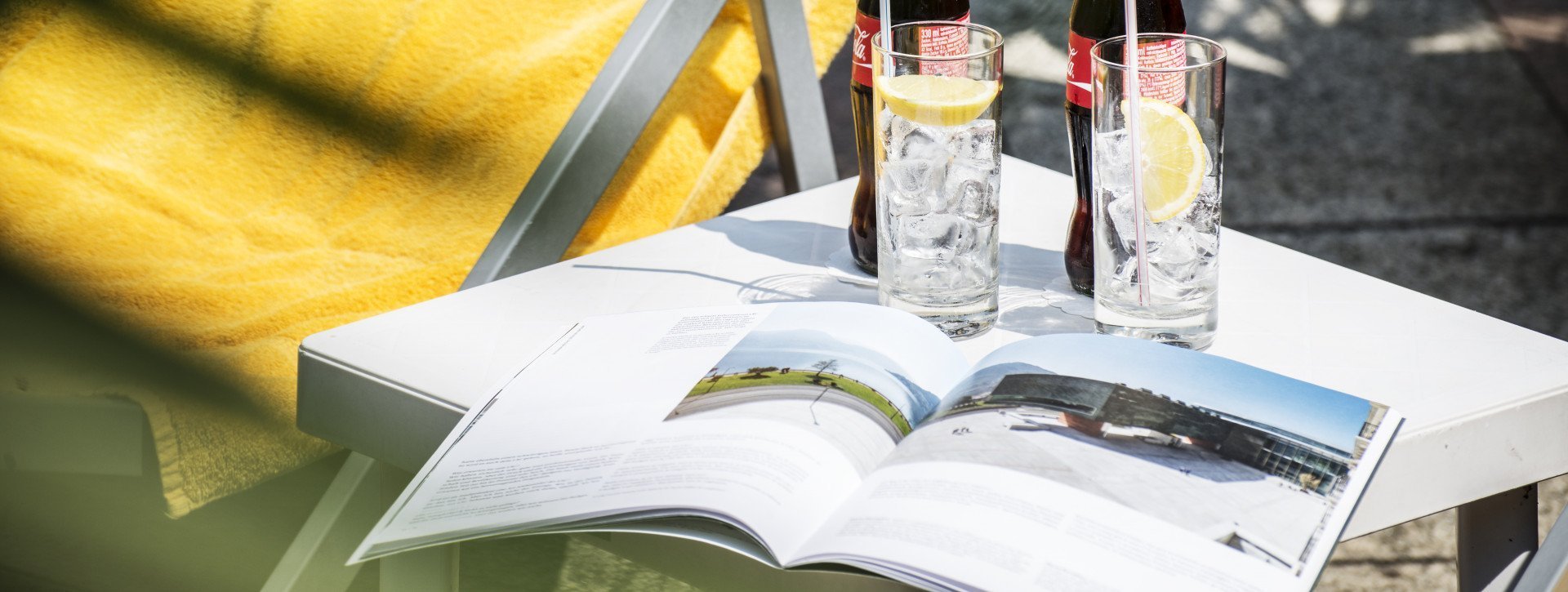 A magazine and two cola in the garden